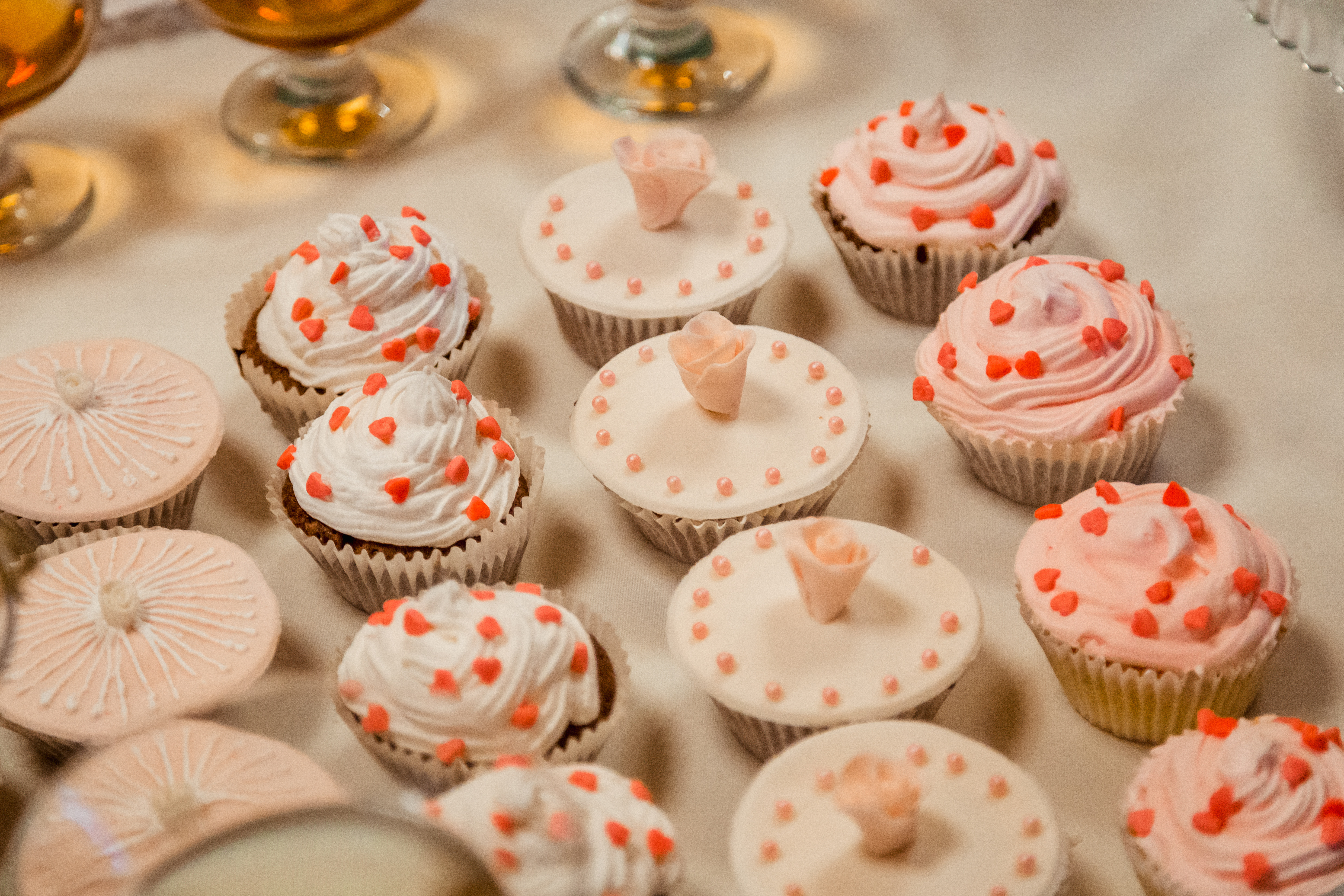 Nice cupcakes with rose sugar and white glaze stand on the white table